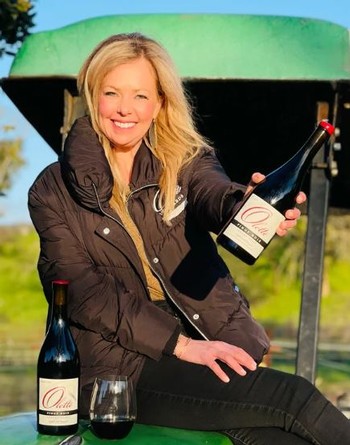 Jenny Lynn holding wines